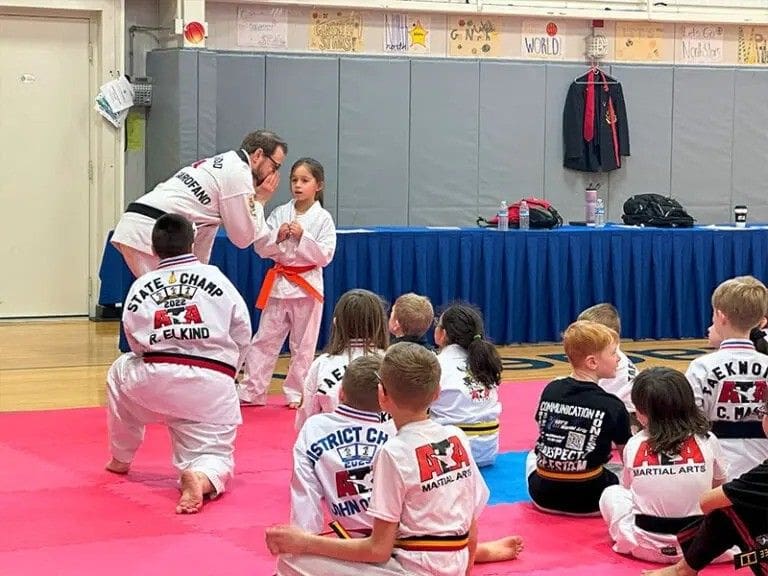 instructor teaching students during kids taekwondo class